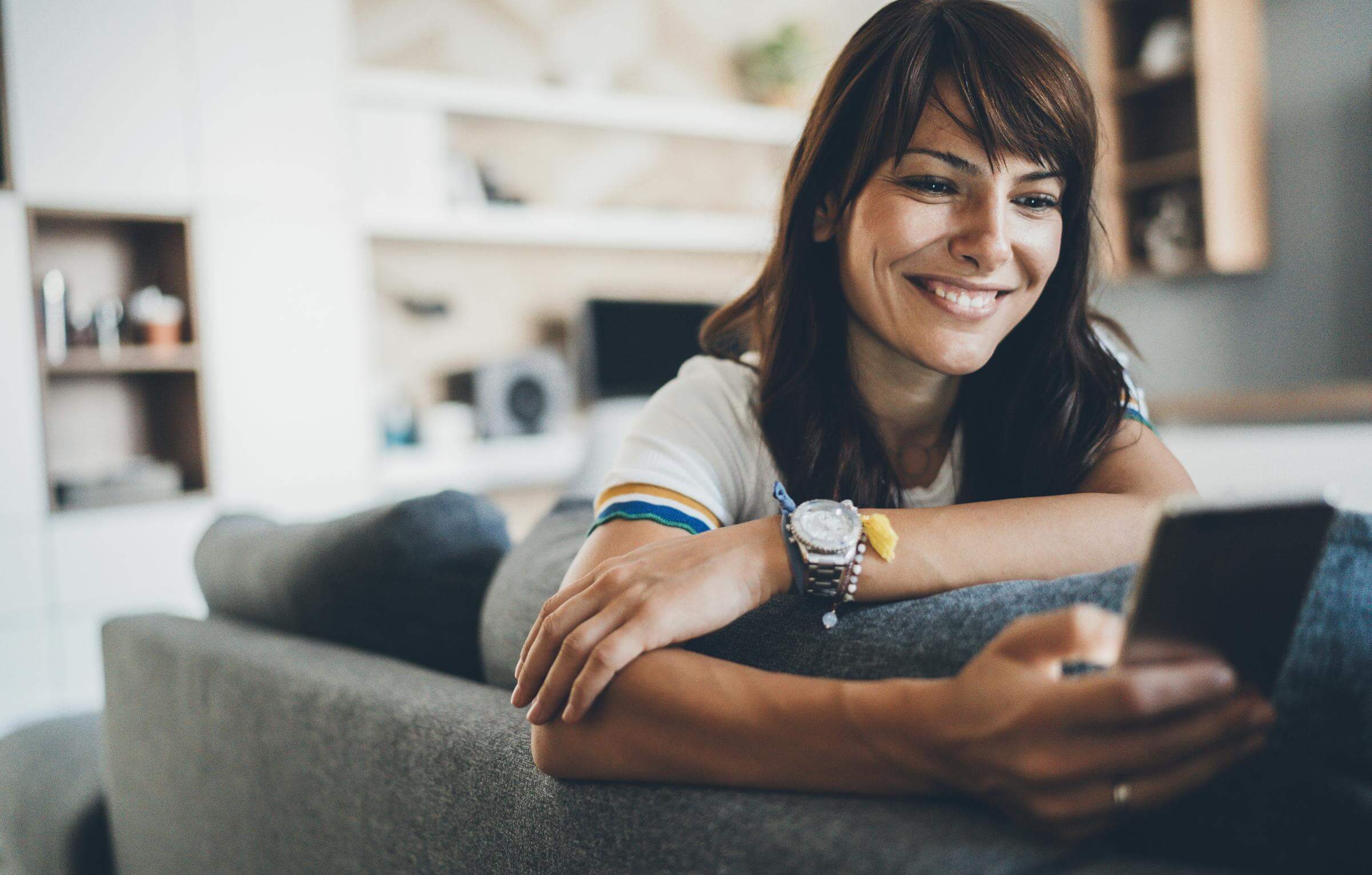 Why you should avoid the most popular lottery numbers Happy-woman-lying-on-sofa-looking-at-mobile